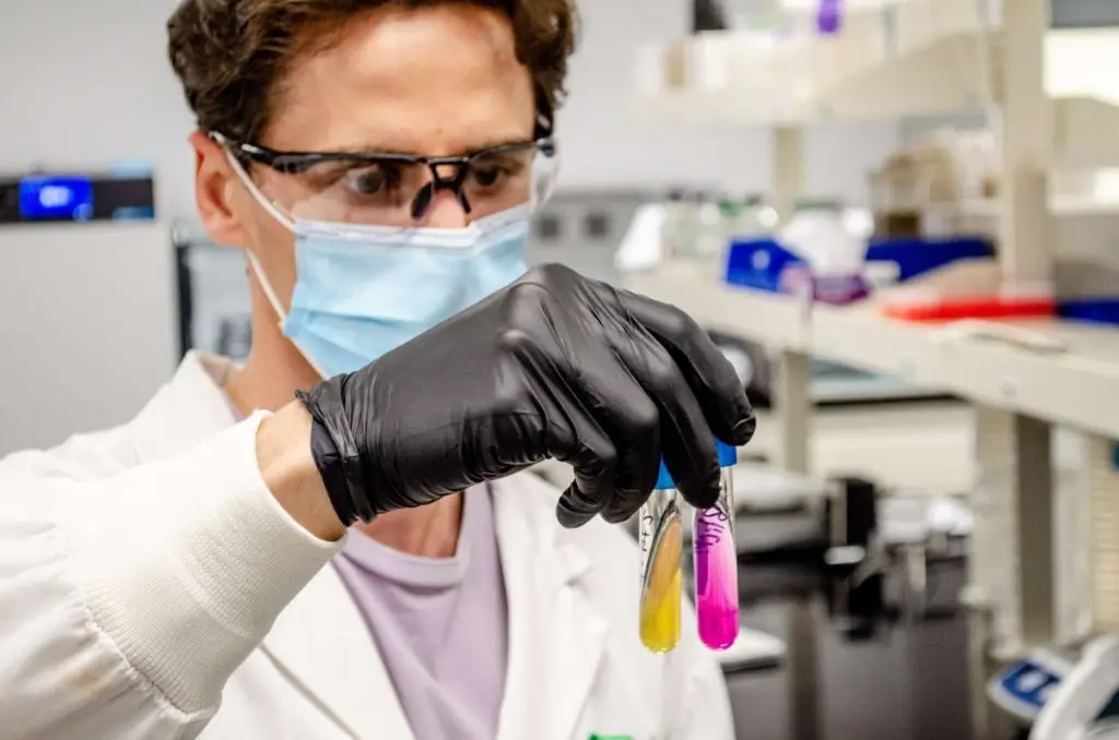 Scientist holding test tubes
